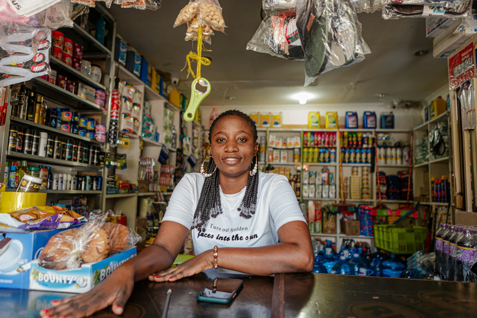 Lagos shop owner at her counter, surrounded by her product stock